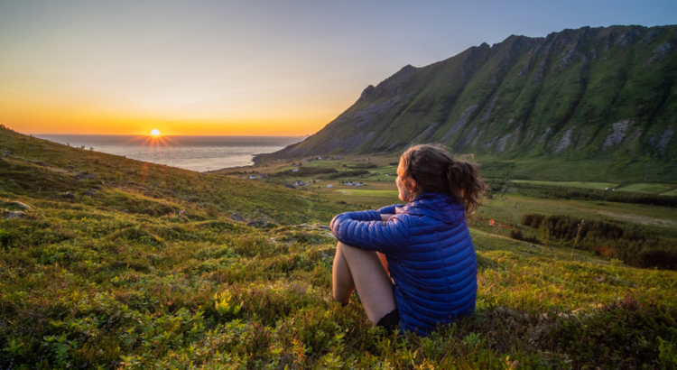 Norwegen Lofoten Mitternachtssonne Frau auf Wiese Foto Ismaele Tortella Visit Norway.jpg