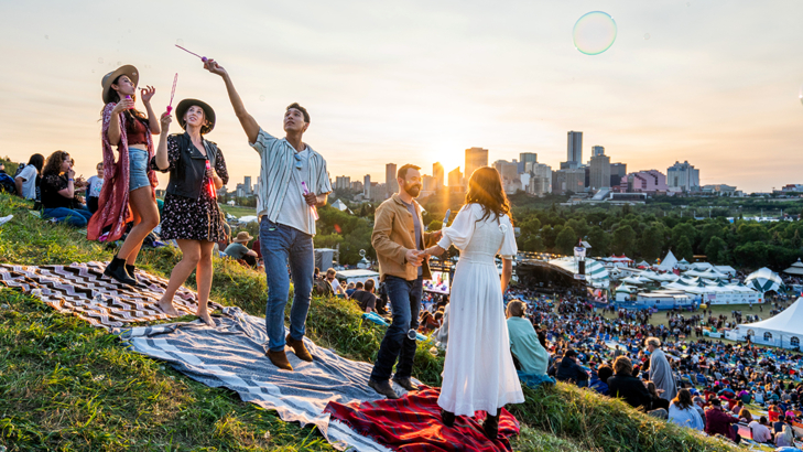 Edmonton Folk Music Festival_A group of friends blows bubbles on top of Gallagher Hill while waiting for the main stage performance.jpg